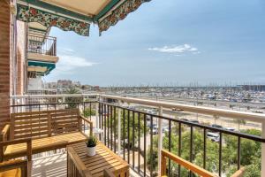 a balcony with a bench and a view of the beach at Sunflower Puerto Rico in Santa Pola