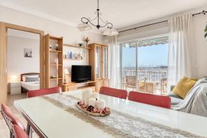 a dining room and living room with a table and chairs at Sunflower Puerto Rico in Santa Pola