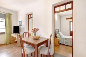 a kitchen and dining room with a table and a television at los diablitos 3c - Ideal familias in San Juan de la Rambla