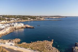 an aerial view of a body of water with houses at Biancolino Apartments in Nardò