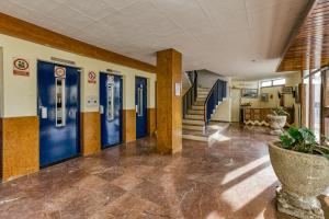 a hallway with blue doors in a building at Marinada in L'Escala