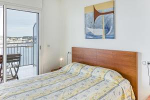 a bedroom with a bed and a balcony at Marinada in L'Escala +26 photos