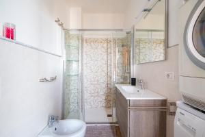 a bathroom with a shower and a toilet and a sink at Casa Jerzu S'essia de su santu in Jerzu