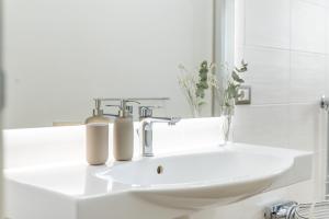 a bathroom with a sink and a mirror at Vico21 nel centro di Modica in Modica +12 photos