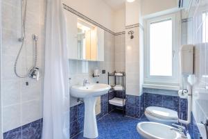 a bathroom with a sink and a toilet and a shower at Liver 202 in Tremosine Sul Garda +24 photos