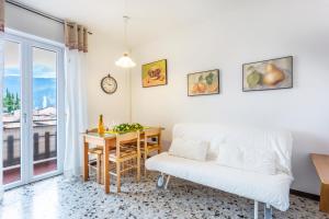 a living room with a table and a white couch at Liver 202 in Tremosine Sul Garda