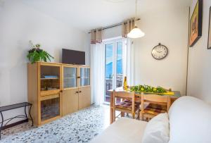 a living room with a table and a clock on the wall at Liver 202 in Tremosine Sul Garda