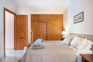 a bedroom with a bed and a wooden door at Apartament Carla in Port de Soller