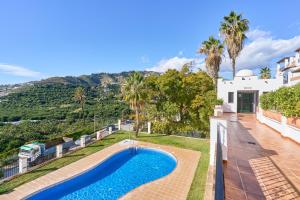 an exterior view of a house with a swimming pool at Costa Luxe Almuñecar in Almuñécar