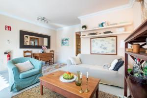 a living room with a couch and a table at Apartament Carla in Port de Soller +17 photos