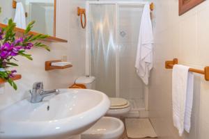 a bathroom with a sink and a toilet at Trilocale N8 - Porto Mannu in Palau