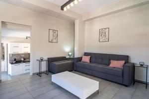 a living room with a couch and a table at Kate House in Ágios Matthaíos