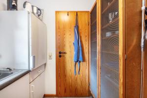 a kitchen with a wooden door and a sink at Sonnige Wohnung im Markgräflerland in Efringen-Kirchen +18 photos