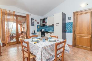 a kitchen and dining room with a table and chairs at Home Residence Barbara in San Teodoro +16 photos