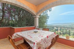 a dining room with a table and chairs on a balcony at Home Residence Barbara in San Teodoro