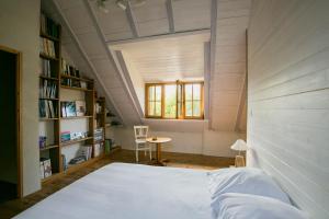 a bedroom with a bed and a table and a window at Moulin du Tourous - Chambre 1 in Plouédern