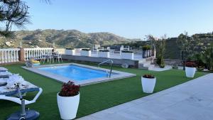 a backyard with a swimming pool and green grass at Entre montañas in Árchez
