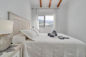 a bedroom with a bed with two remote controls on it at Entre montañas in Árchez +27 photos