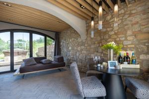a living room with a table and a couch at Suite Orcio in San Gimignano