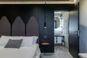a bedroom with a bed and a bathroom with a sink at Suite Orcio in San Gimignano