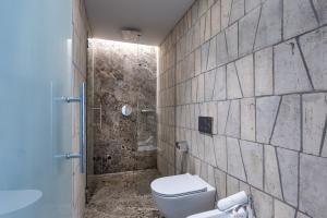 a bathroom with a toilet and a shower at Suite Orcio in San Gimignano +17 photos
