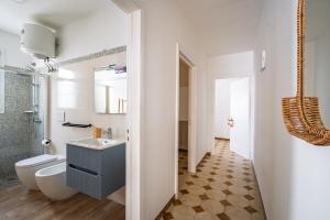 a bathroom with a sink and a toilet at Blue Bay Lux House in Torre Lapillo