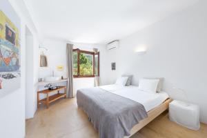 a white bedroom with a bed and a sink at Dream Property in Alconasser in Sóller +37 photos