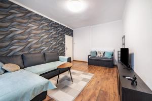 a living room with a couch and a television at Ferienwohnung Krause Dachgeschoss in Wilhelmshaven