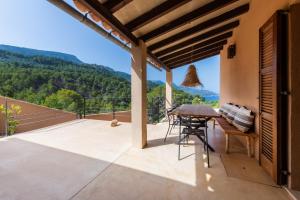 a patio with a table and chairs and a view at Dream Property in Alconasser in Sóller