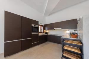a kitchen with dark brown cabinets and a counter at Dream Property in Alconasser in Sóller