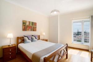 a bedroom with a large bed and a window at Vilamoura Marina in Vilamoura +23 photos