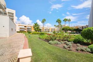 a park with a bench next to a building at Vilamoura Marina in Vilamoura