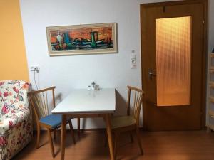 a room with a table and chairs and a door at Ferienwohnung Mi Ka mit Garten in Limburg an der Lahn