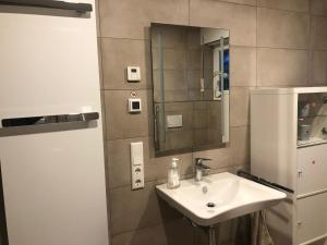 a bathroom with a sink and a mirror at Ferienwohnung Mi Ka mit Garten in Limburg an der Lahn +22 photos