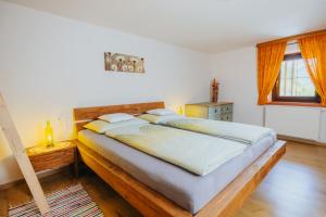 a bedroom with a large bed with a wooden headboard at Maso Fallmerayer - Fallmerayerhof in Bressanone