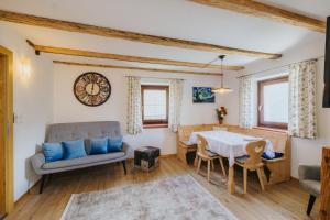 a living room with a couch and a table at Maso Fallmerayer - Fallmerayerhof in Bressanone
