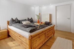 a bedroom with a large bed with a wooden frame at am Hochrhein Desko in Gailingen