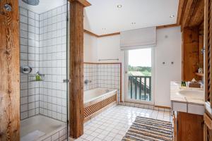 a bathroom with a bath tub and a window at Windhäusern5 in Wangen im Allgäu +26 photos