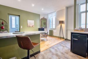 a living room with a counter and a chair at Trois Clés Apartment 1 - 1 bed in Eymet