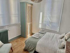 a bedroom with a bed with towels on it at Trois Clés Apartment 1 - 1 bed in Eymet