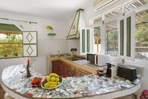 a kitchen with a table with a bowl of fruit on it at Finca Fani 4 in Agüimes