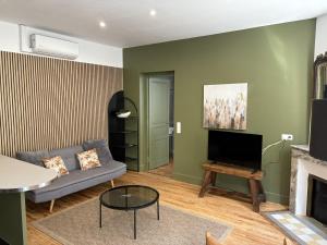 a living room with a couch and a fireplace at Trois Clés Apartment 1 - 1 bed in Eymet