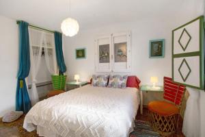 a bedroom with a bed and two tables and two lamps at Finca Fani 4 in Agüimes +17 photos