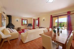 a living room with a table and a dining room at Cas Cans in Artá