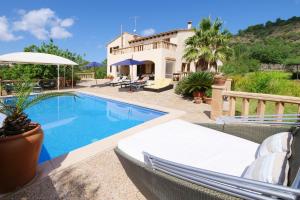a villa with a swimming pool and a house at Cas Cans in Artá