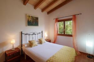a bedroom with a bed and a window at Cas Cans in Artá +29 photos