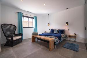 a bedroom with a bed and a chair at Villa bord de mer avec piscine in Hyères +26 photos