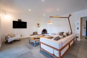 a living room with a couch and a table at Villa bord de mer avec piscine in Hyères