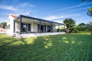 a house with a large lawn in front of it at Villa bord de mer avec piscine in Hyères