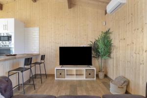 a living room with a flat screen tv on a cabinet at Villa Fatema in Conil de la Frontera